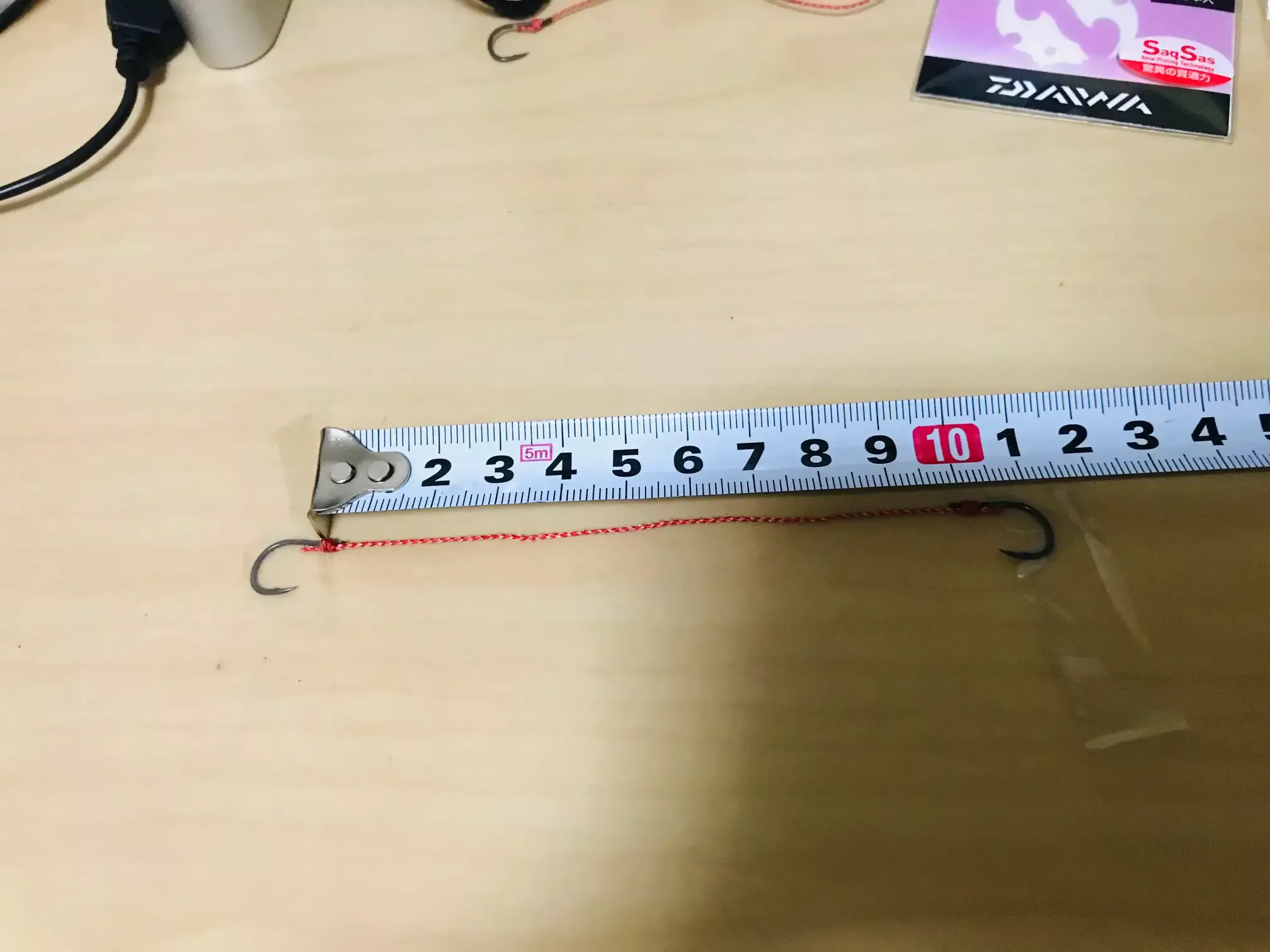 ダイワ系タイラバフックの長さを測っている様子